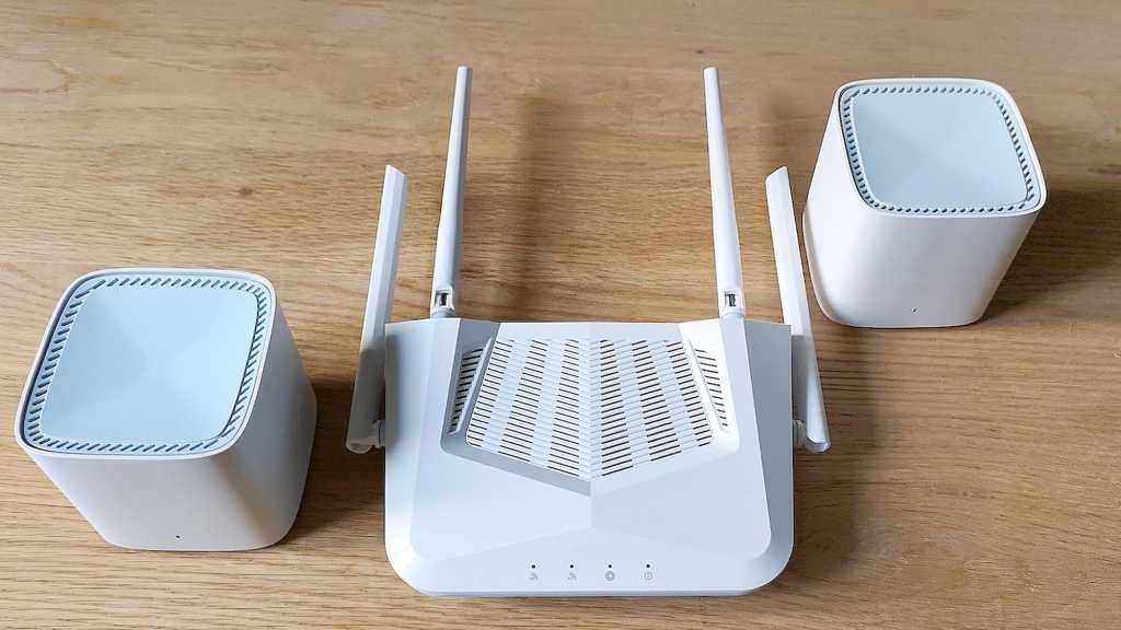 Router and mesh satellites on wooden desk